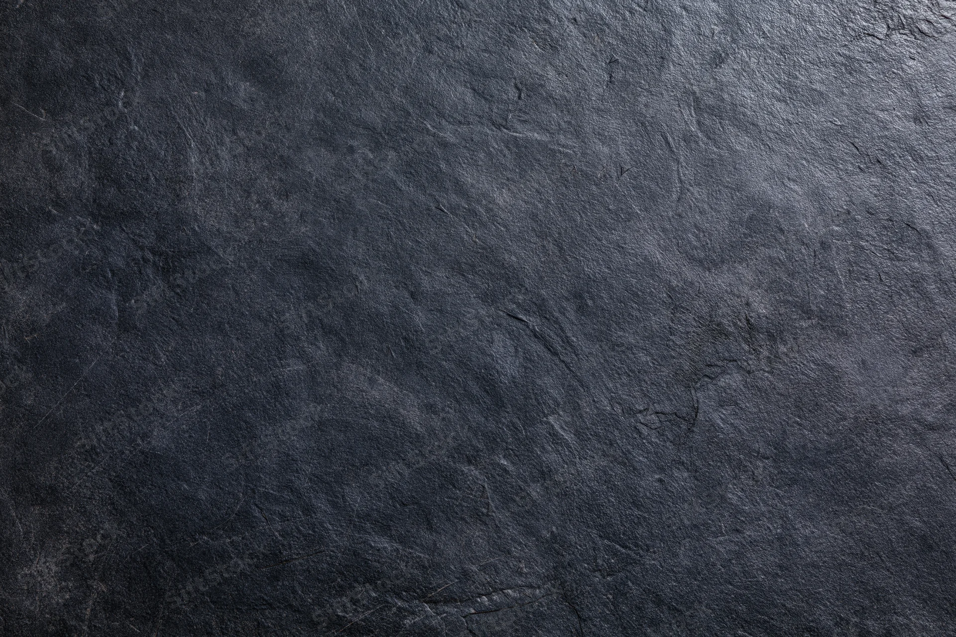 Dark weathered concrete wall surface filling the frame