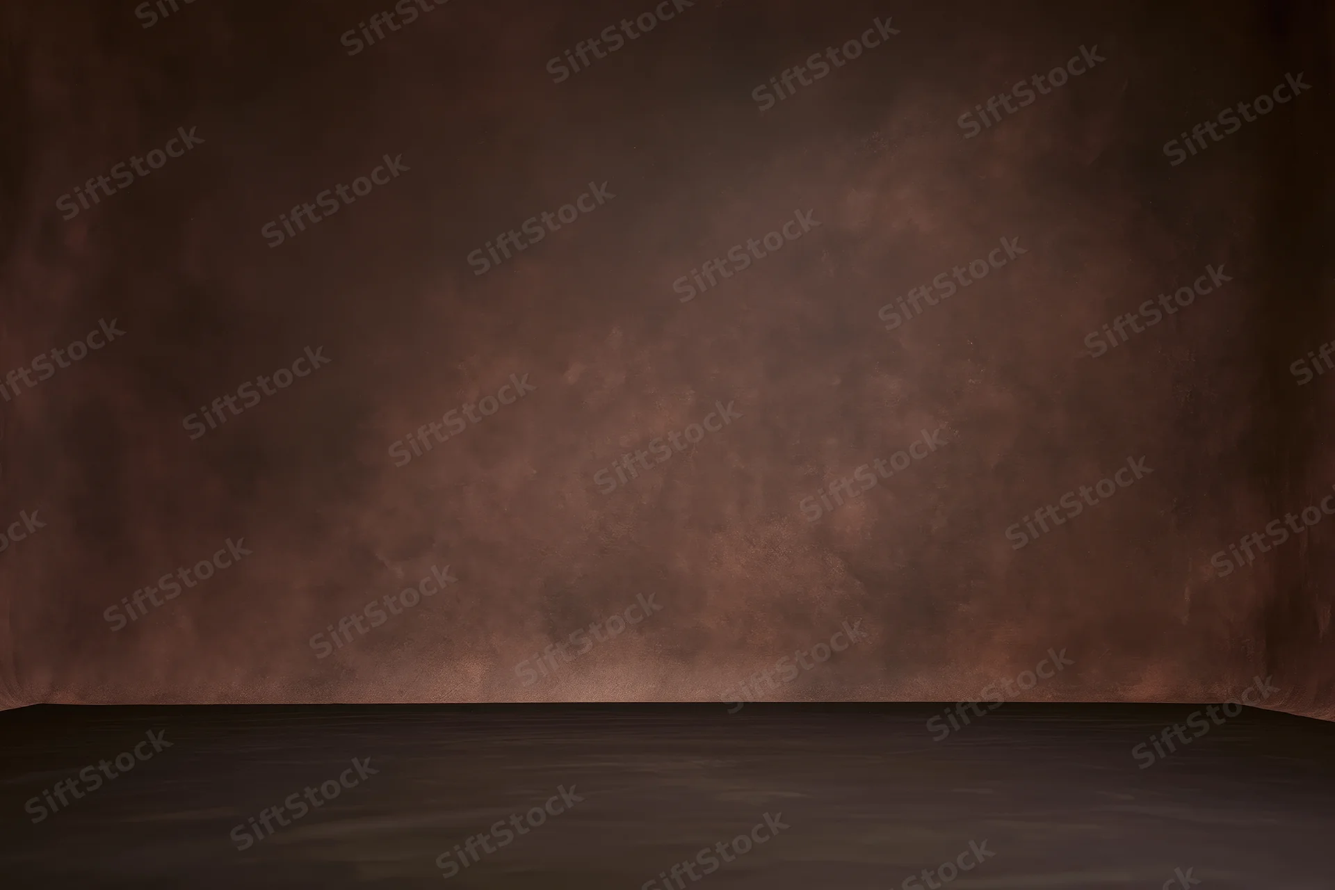 Empty studio backdrop with mottled dark brown painted wall and dark floor