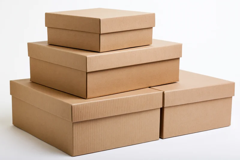 Stepped stack of closed corrugated cardboard boxes on white background