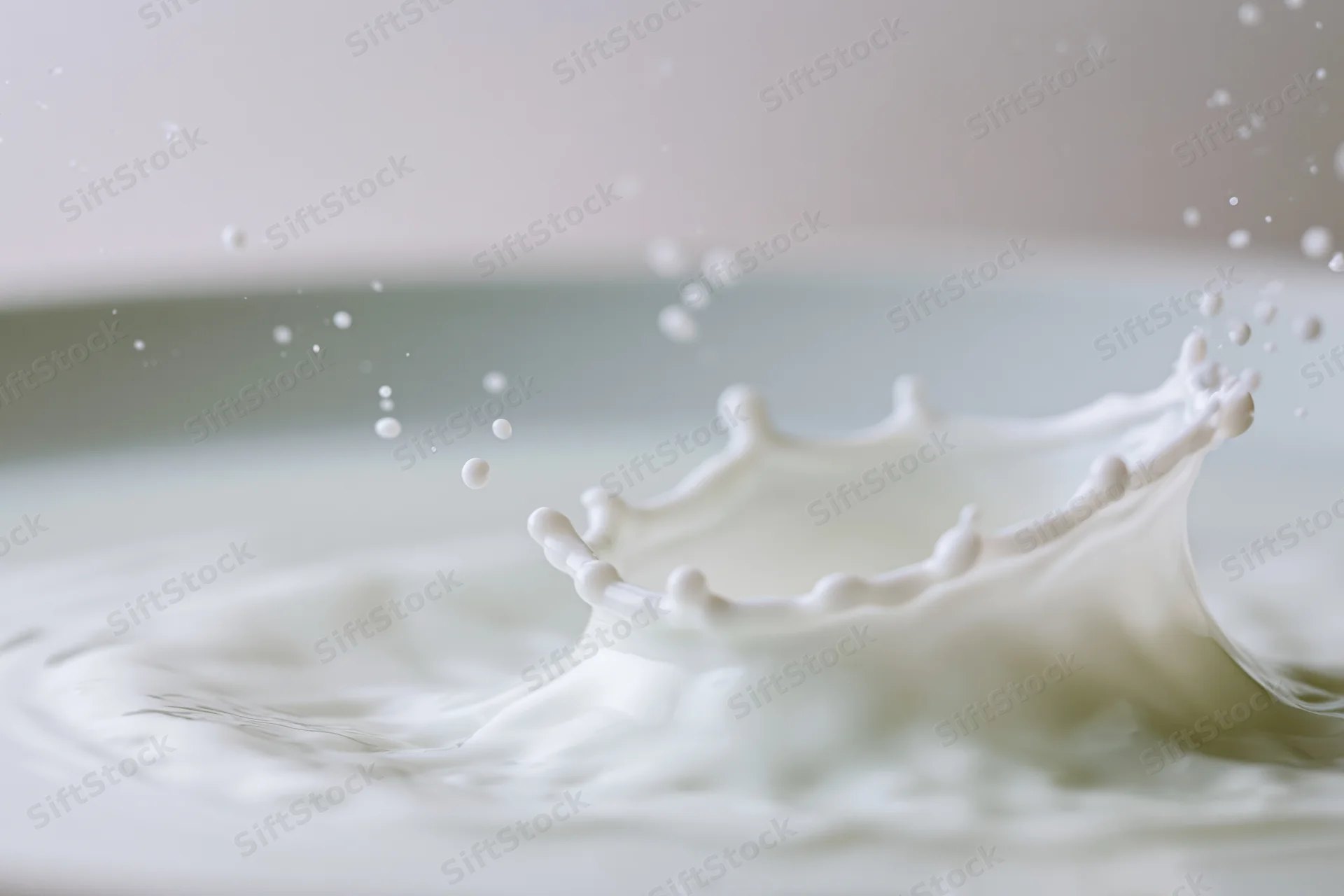 Milk splash forming a crown shape with droplets suspended mid-air