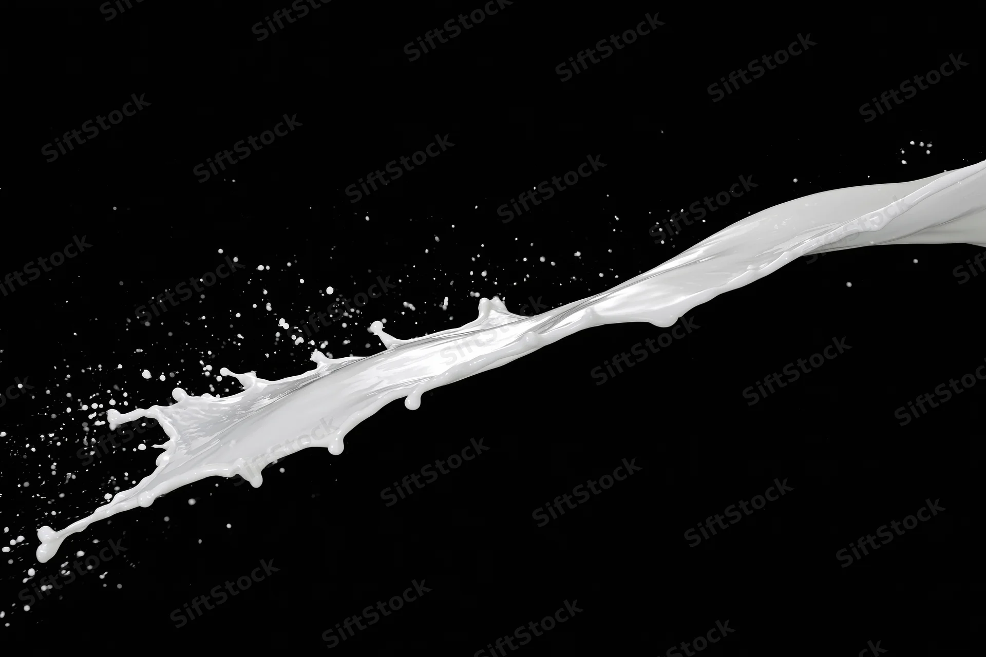 Diagonal milk splash mid-air against black background