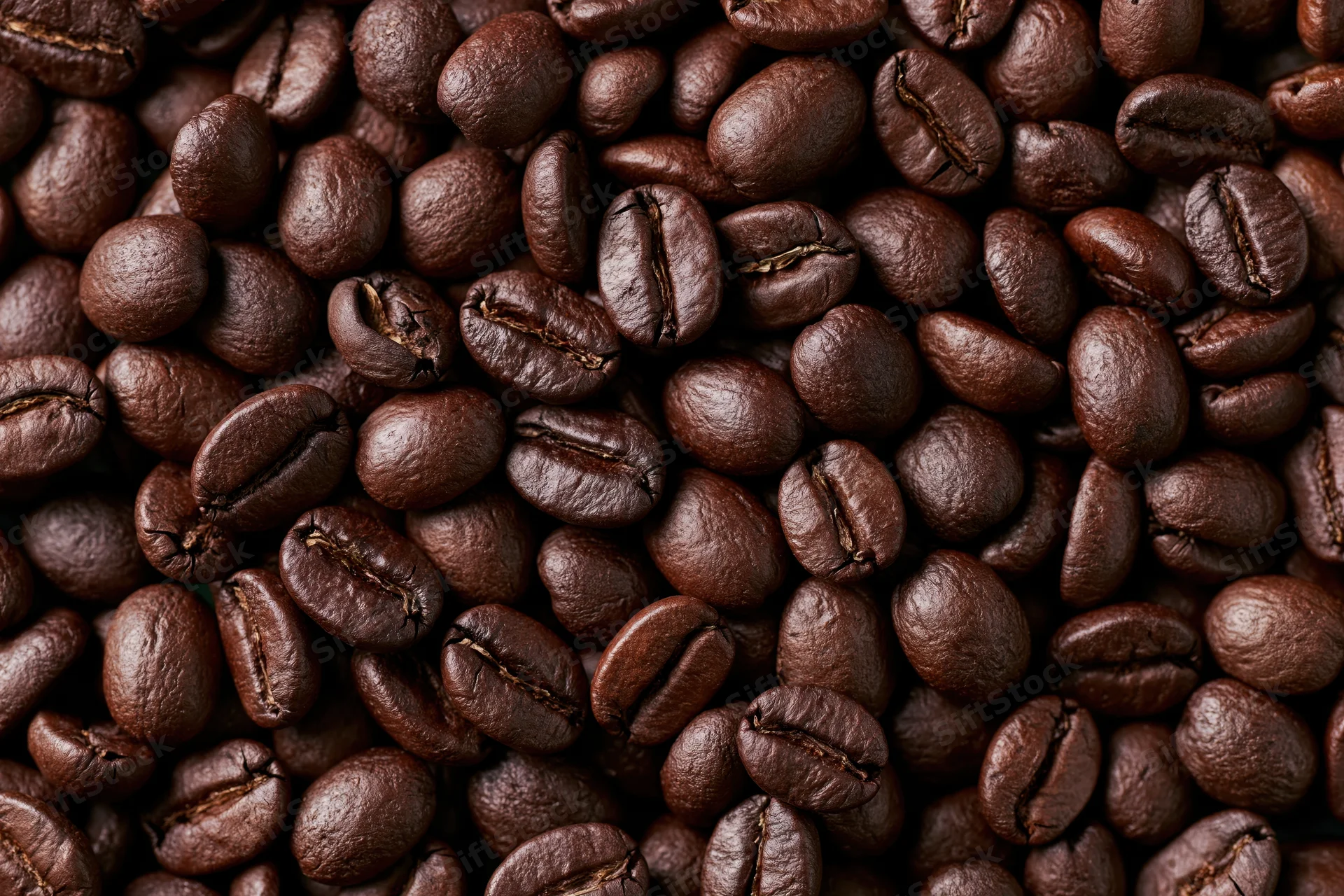 Closeup of dark roasted coffee beans filling the frame