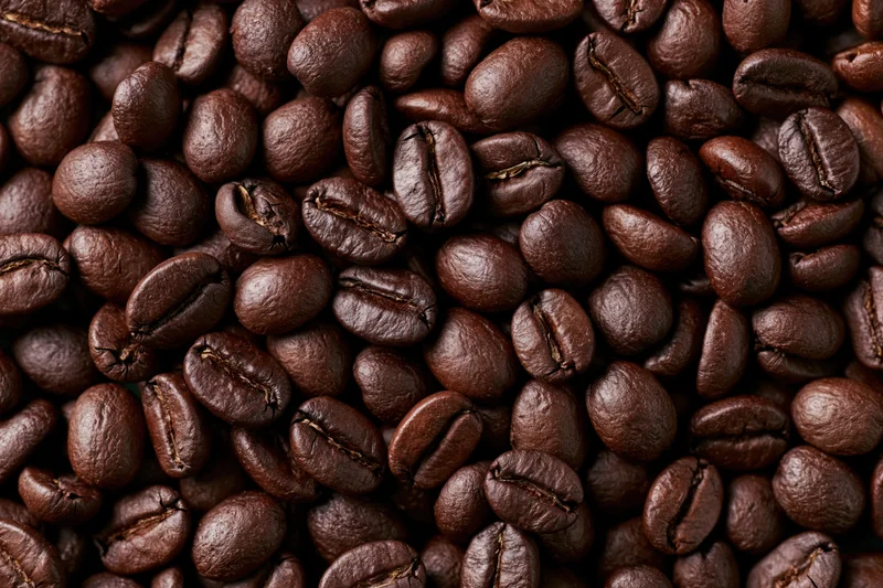 Closeup of dark roasted coffee beans filling the frame