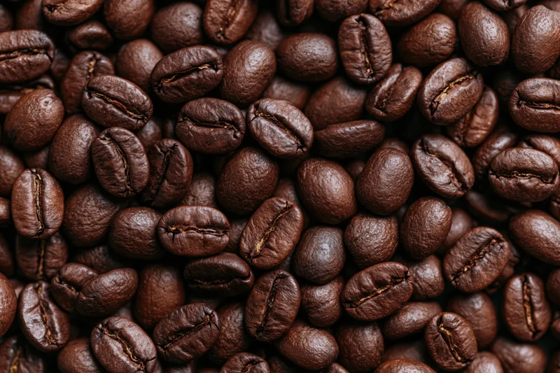 Closeup of dark roasted coffee beans filling the frame