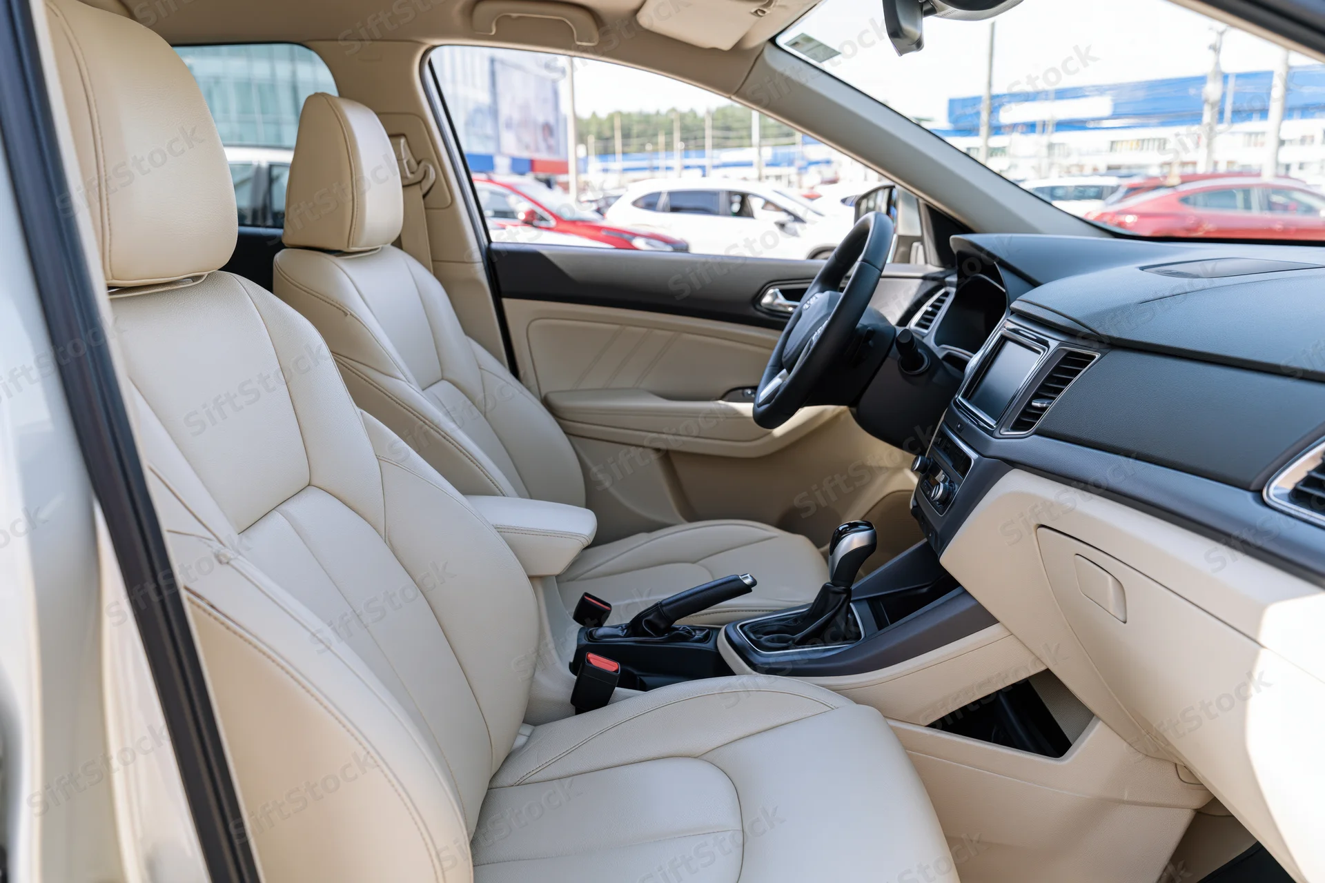Beige leather seats and dashboard in a modern compact SUV interior viewed from passenger side door