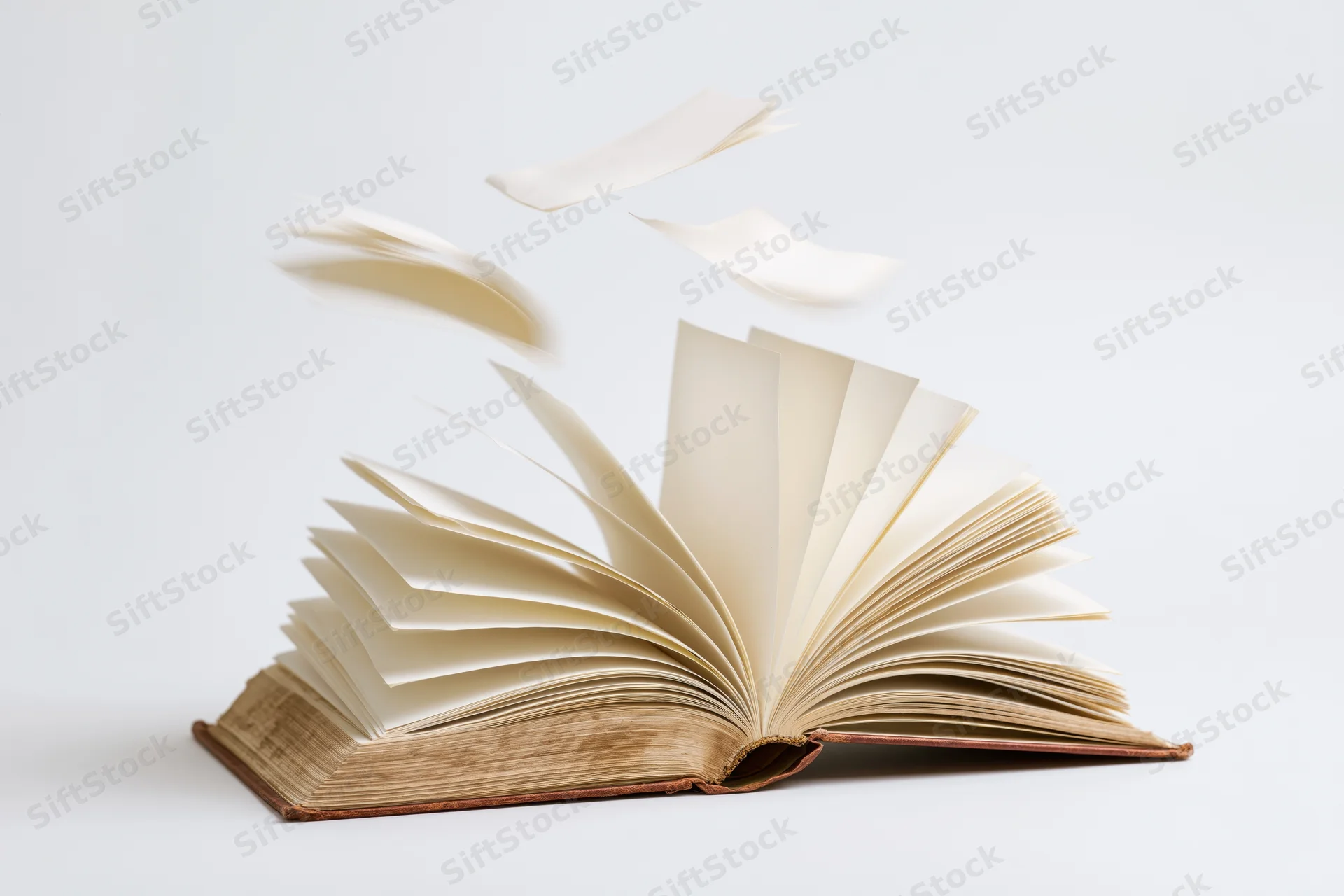 Open hardcover book with pages flying and scattered on white background