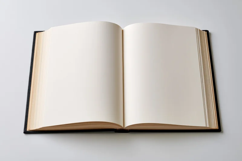 Open hardcover book with blank cream pages lying flat spread on white background