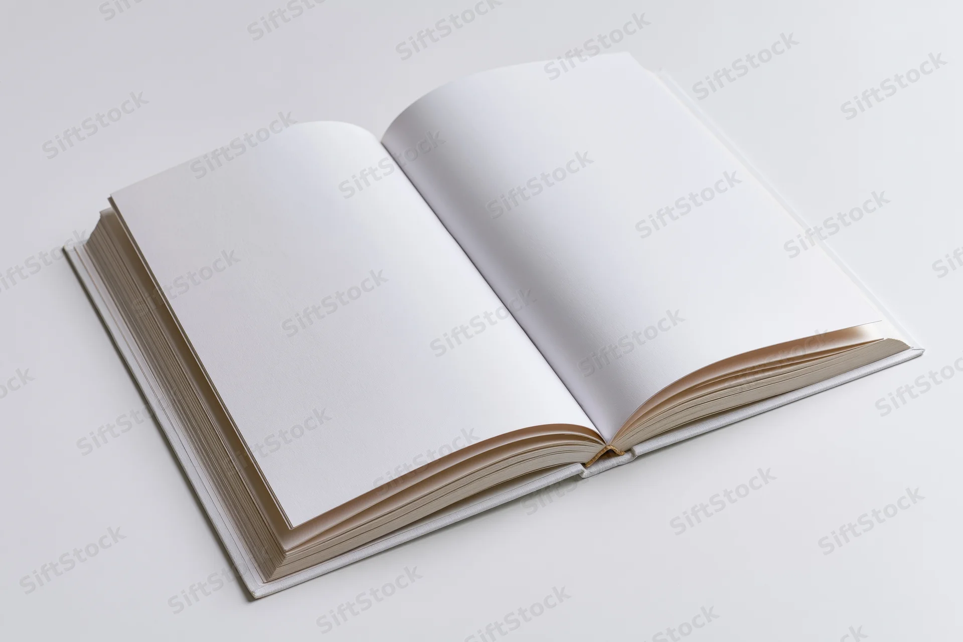 Open hardcover book with blank white pages spread flat on white background