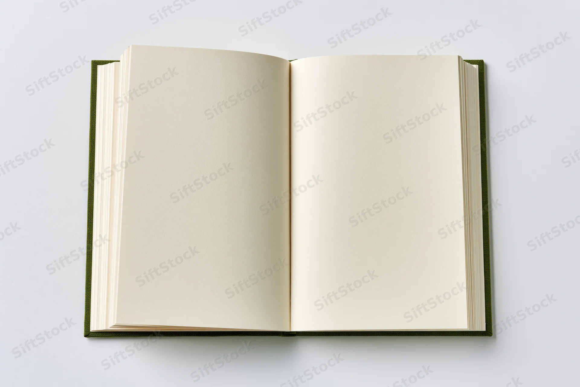 Open hardcover notebook lying flat on white surface with blank cream pages viewed from directly overhead