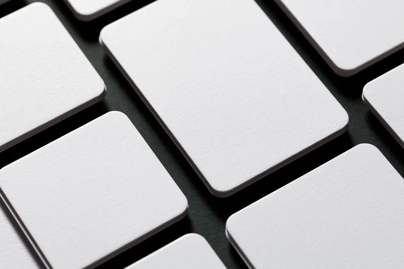 Blank white rounded-rectangle cards arranged in a diagonal grid on dark surface
