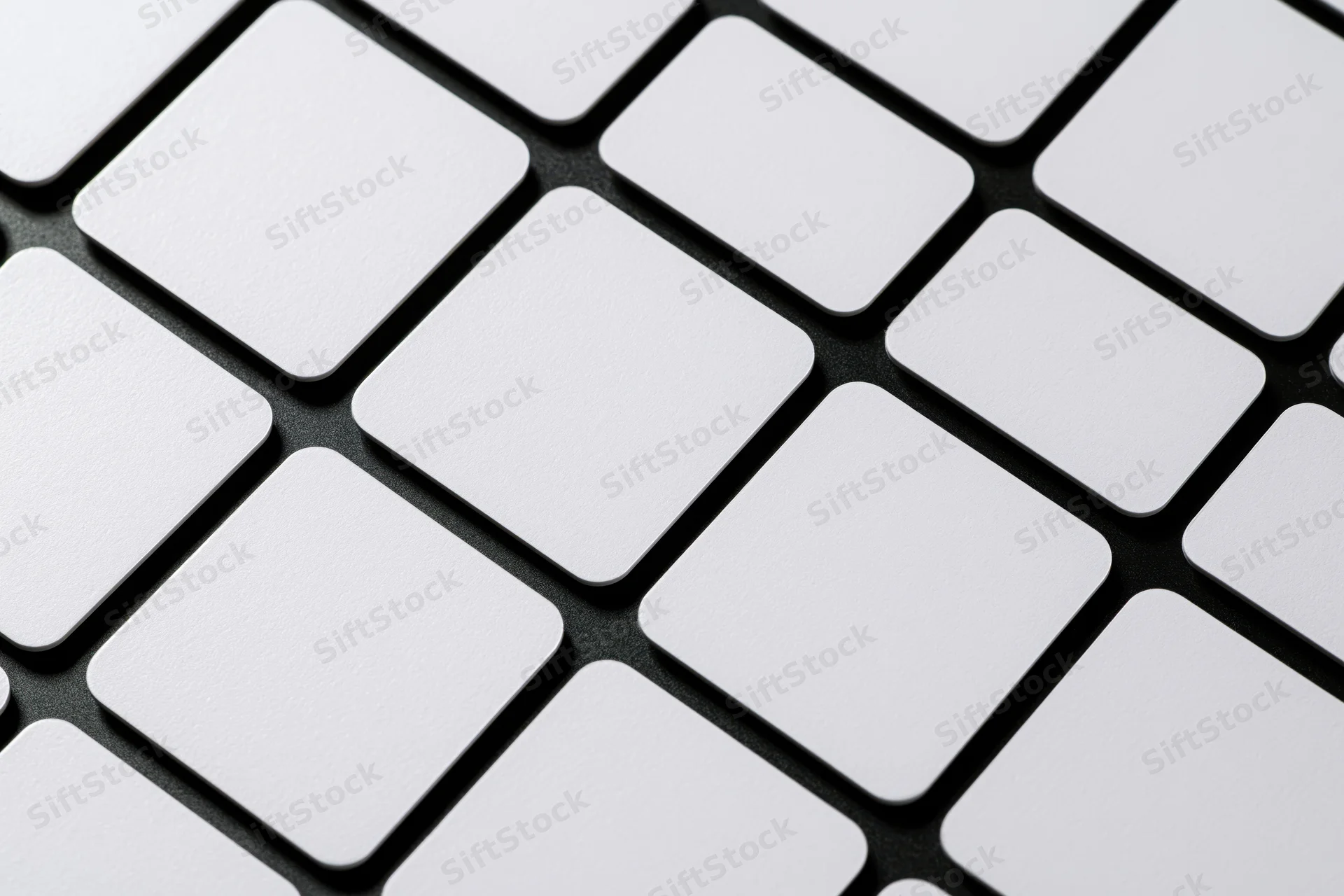 White rounded rectangle cards arranged in diagonal grid pattern on black surface