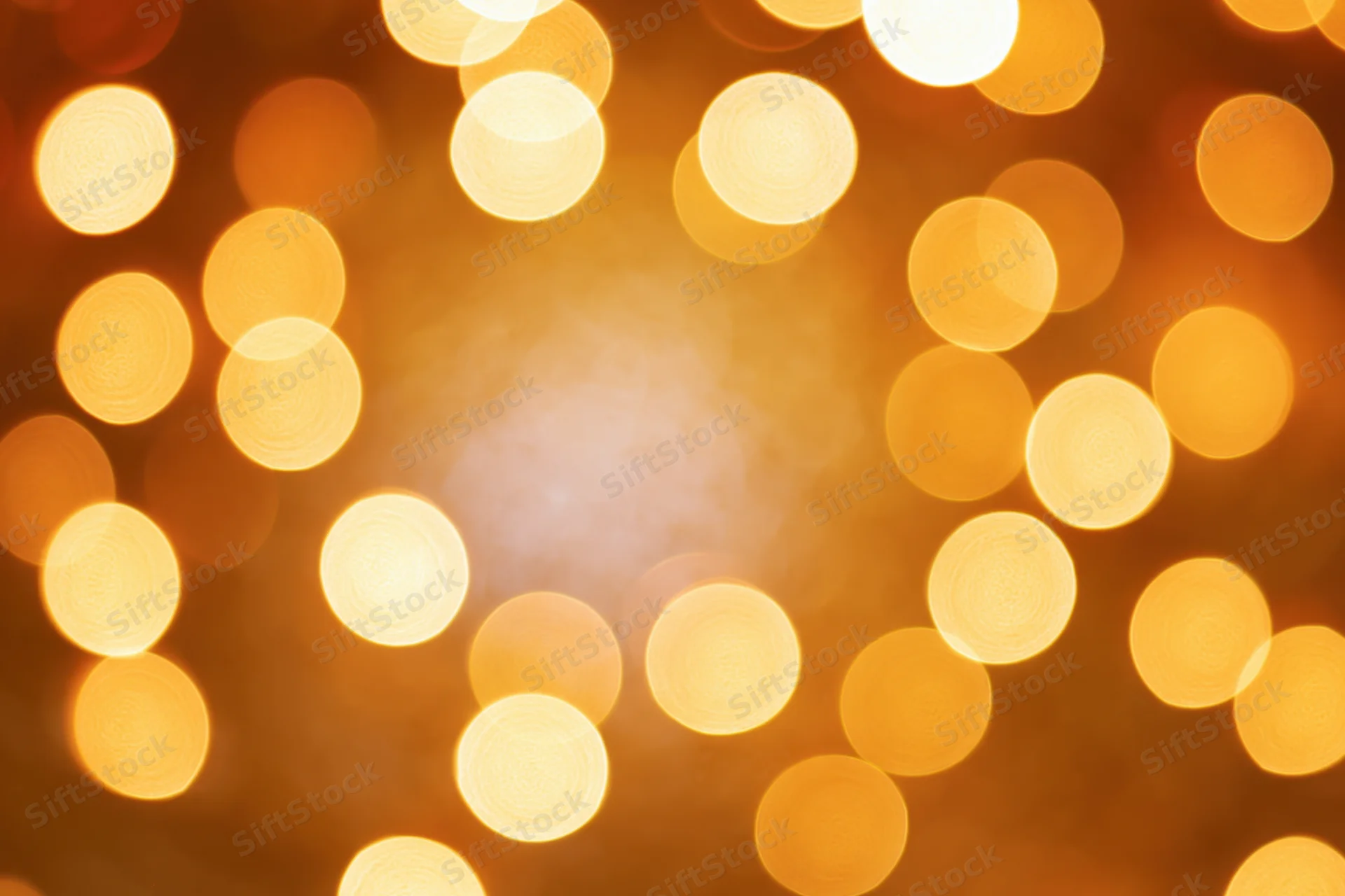 Soft out-of-focus circular lights arranged in a warm glowing pattern with central copyspace