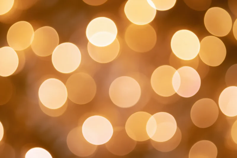 Soft golden bokeh lights in a festive holiday background
