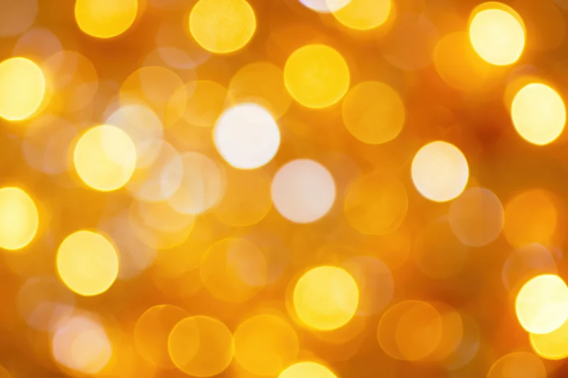 Soft out-of-focus bokeh background with golden circular lights glowing warmly