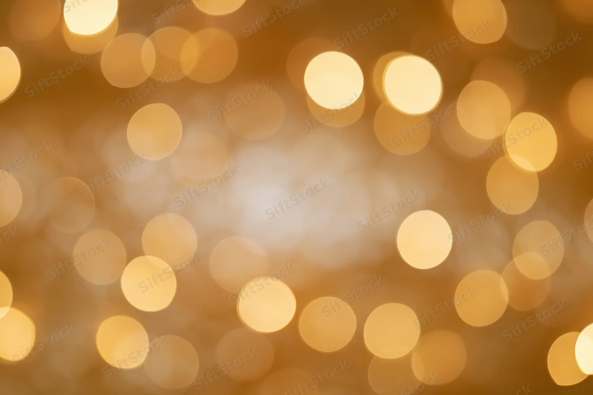Soft golden bokeh lights in circular blur as festive background
