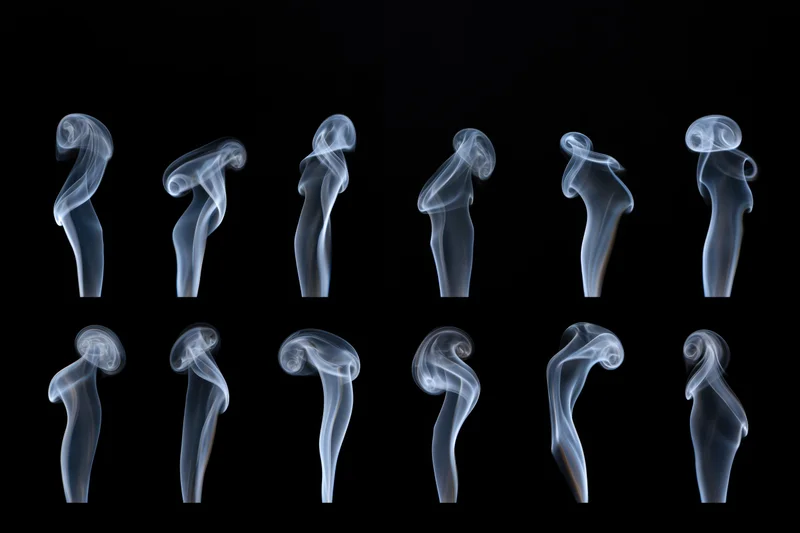 Ten white smoke plumes arranged in two rows against a black background