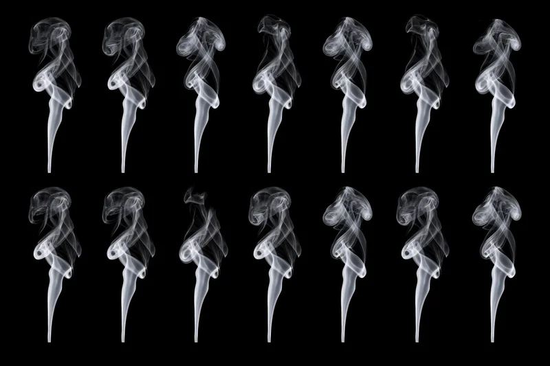White smoke plumes arranged in two rows against black background
