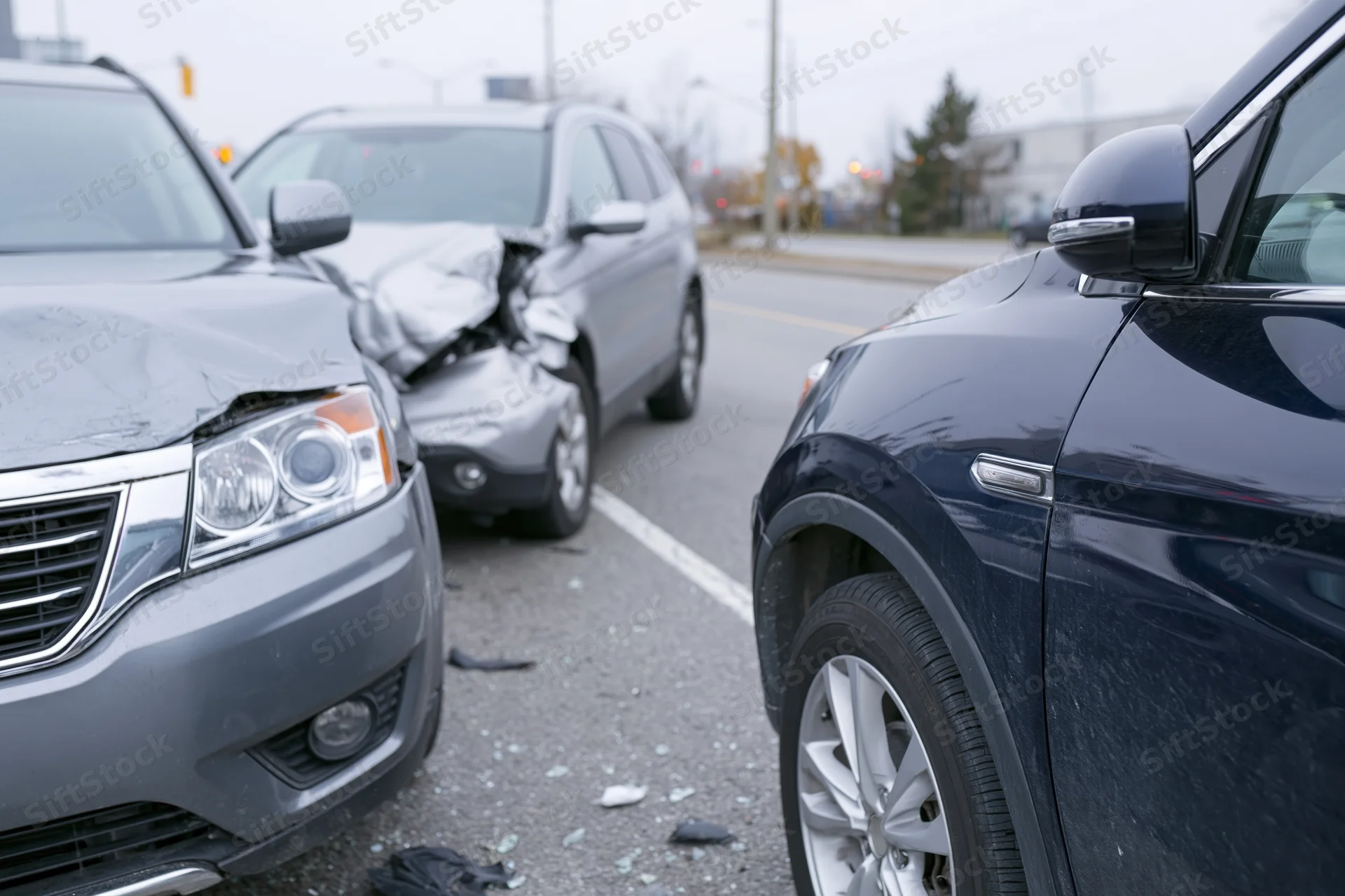 Two suvs with front-end damage after collision on urban road