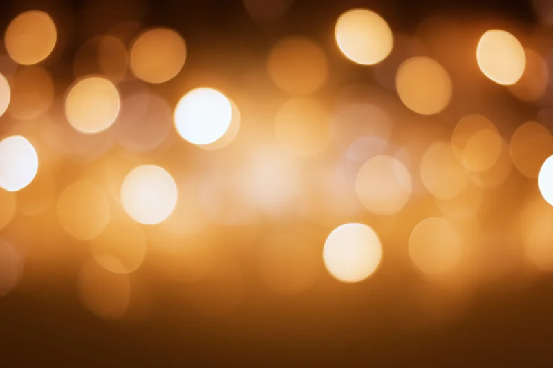 Warm golden bokeh lights scattered across a soft blurred background