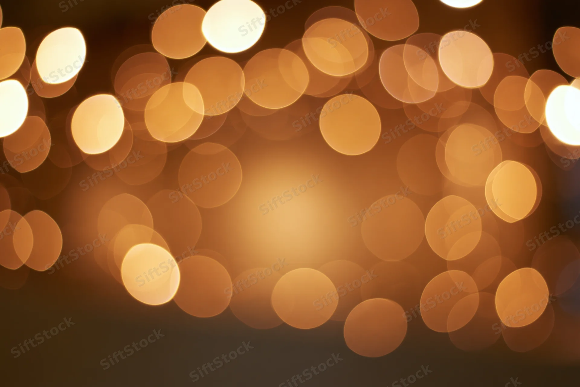 Warm golden bokeh lights scattered across a blurred background creating a festive ambiance