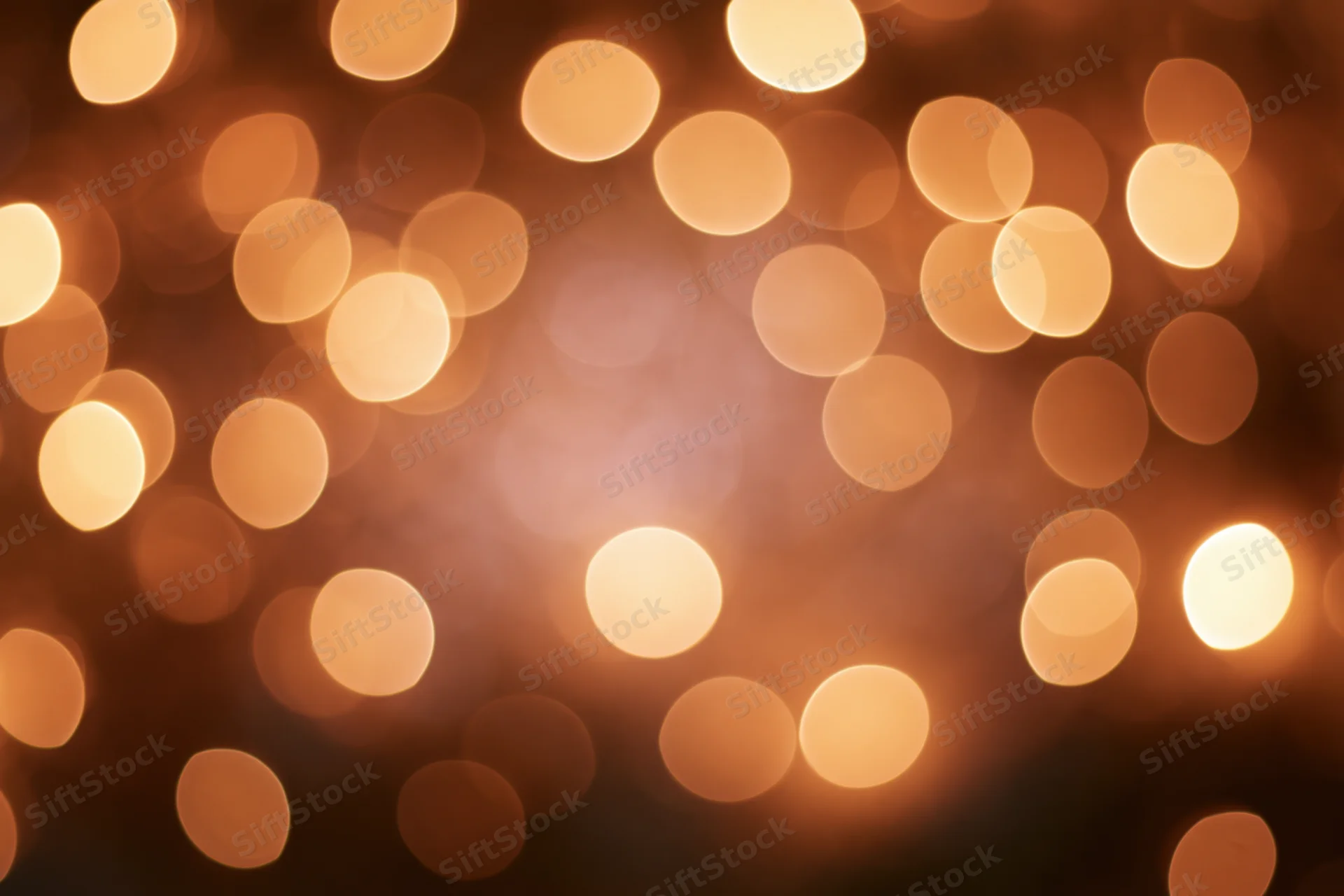 Warm golden bokeh lights scattered across a soft blurred background