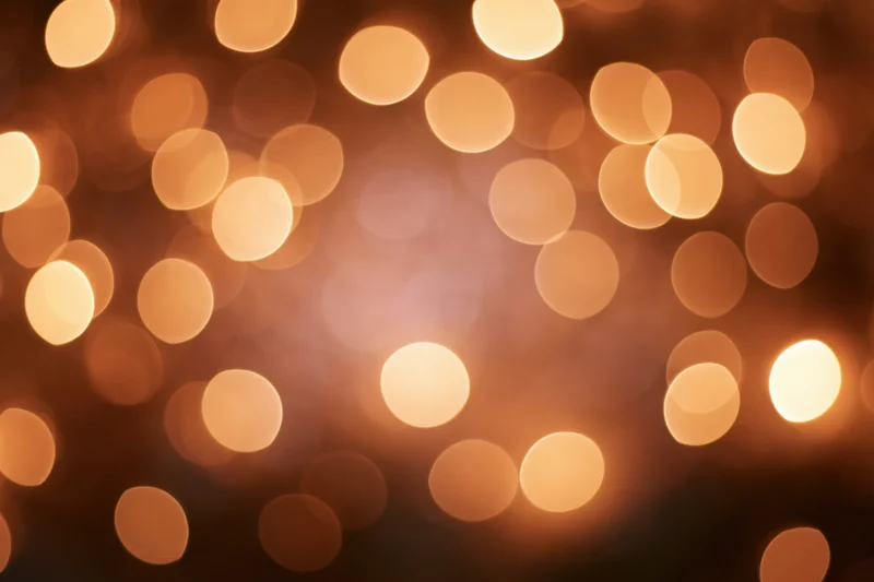 Warm golden bokeh background with scattered soft circular lights