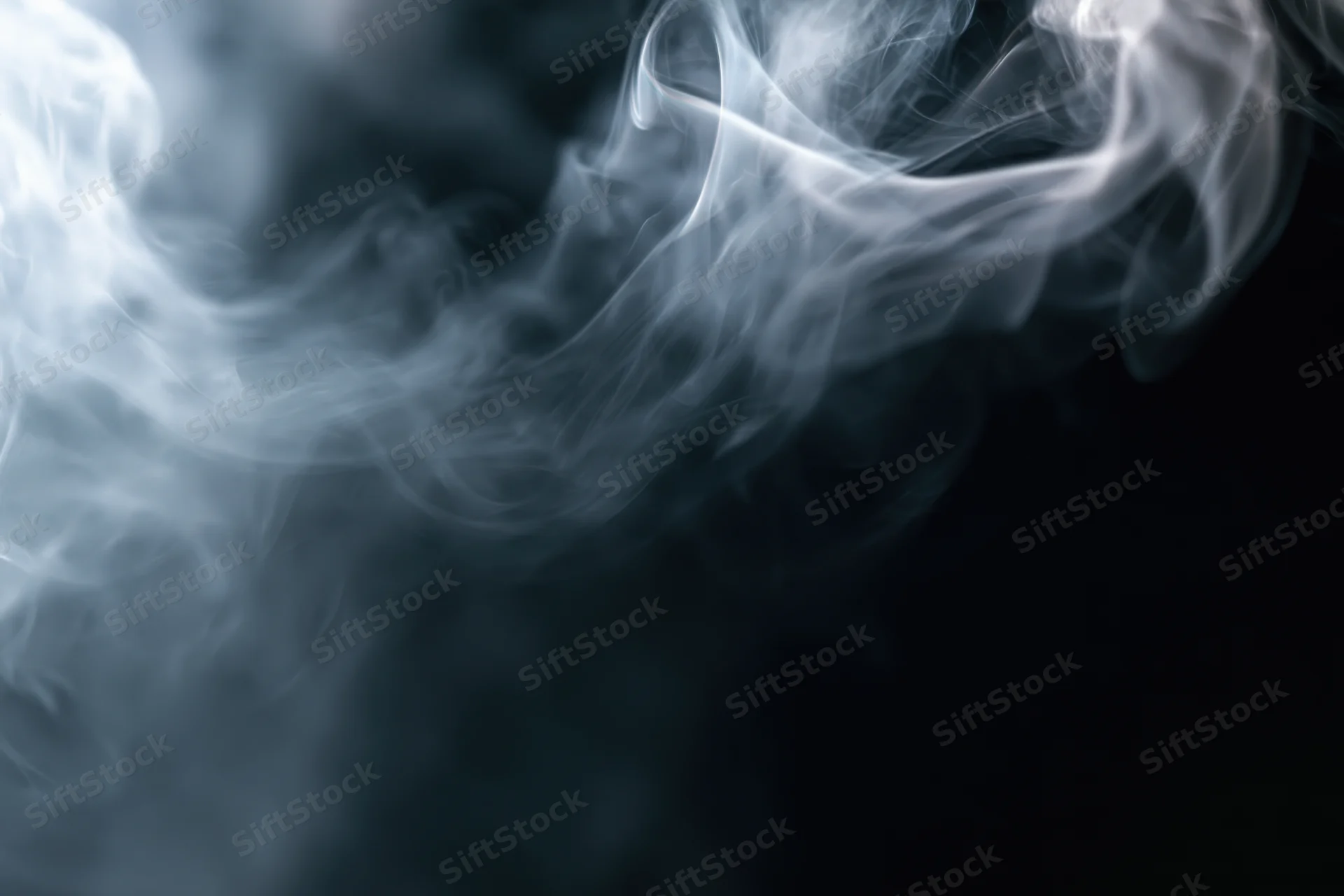 White smoke swirling upward against a dark background