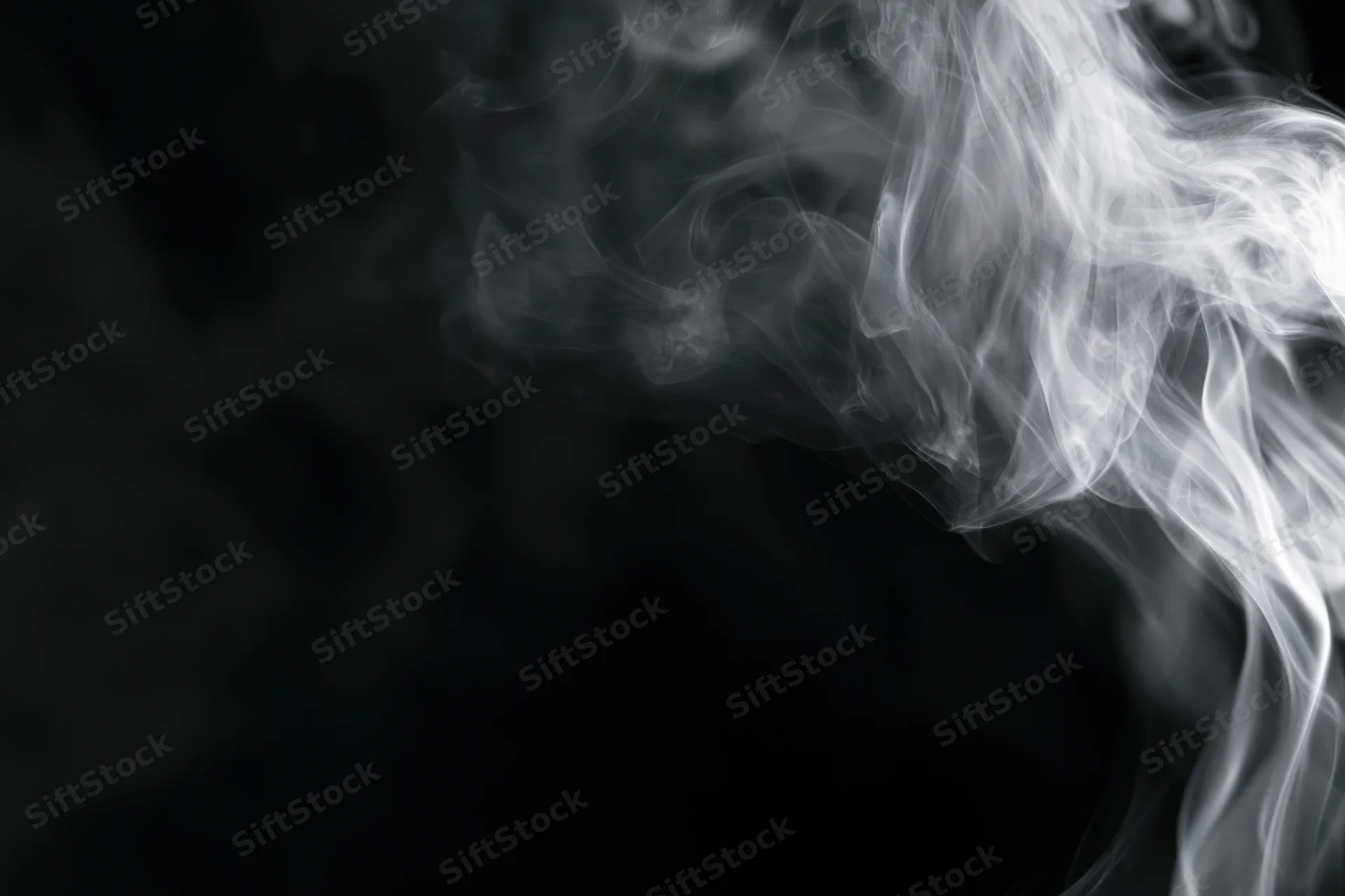Wispy white smoke swirling upward against a black background
