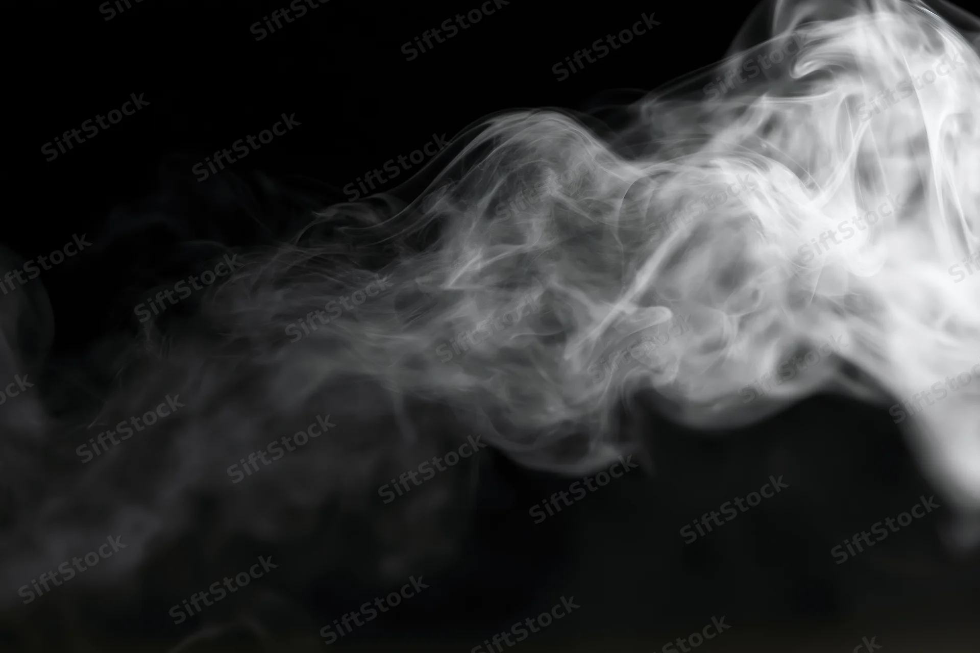 White smoke swirling upward against a black background