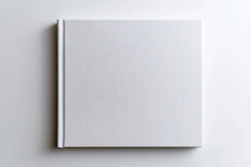 Blank square hardcover book lying flat on white surface