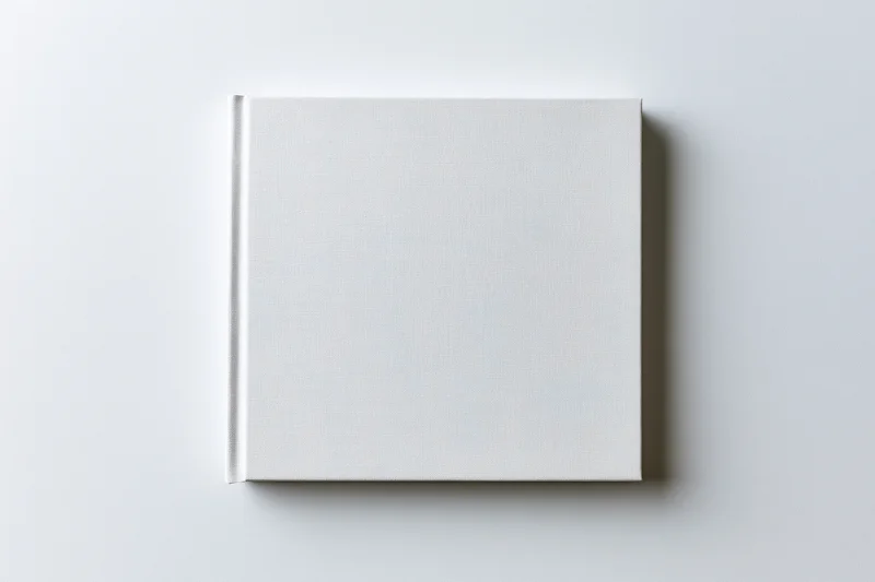 Blank square hardcover book lying flat on white surface
