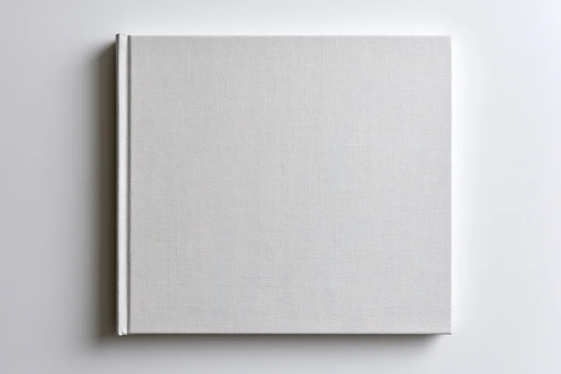 Blank square hardcover book lying flat on white surface