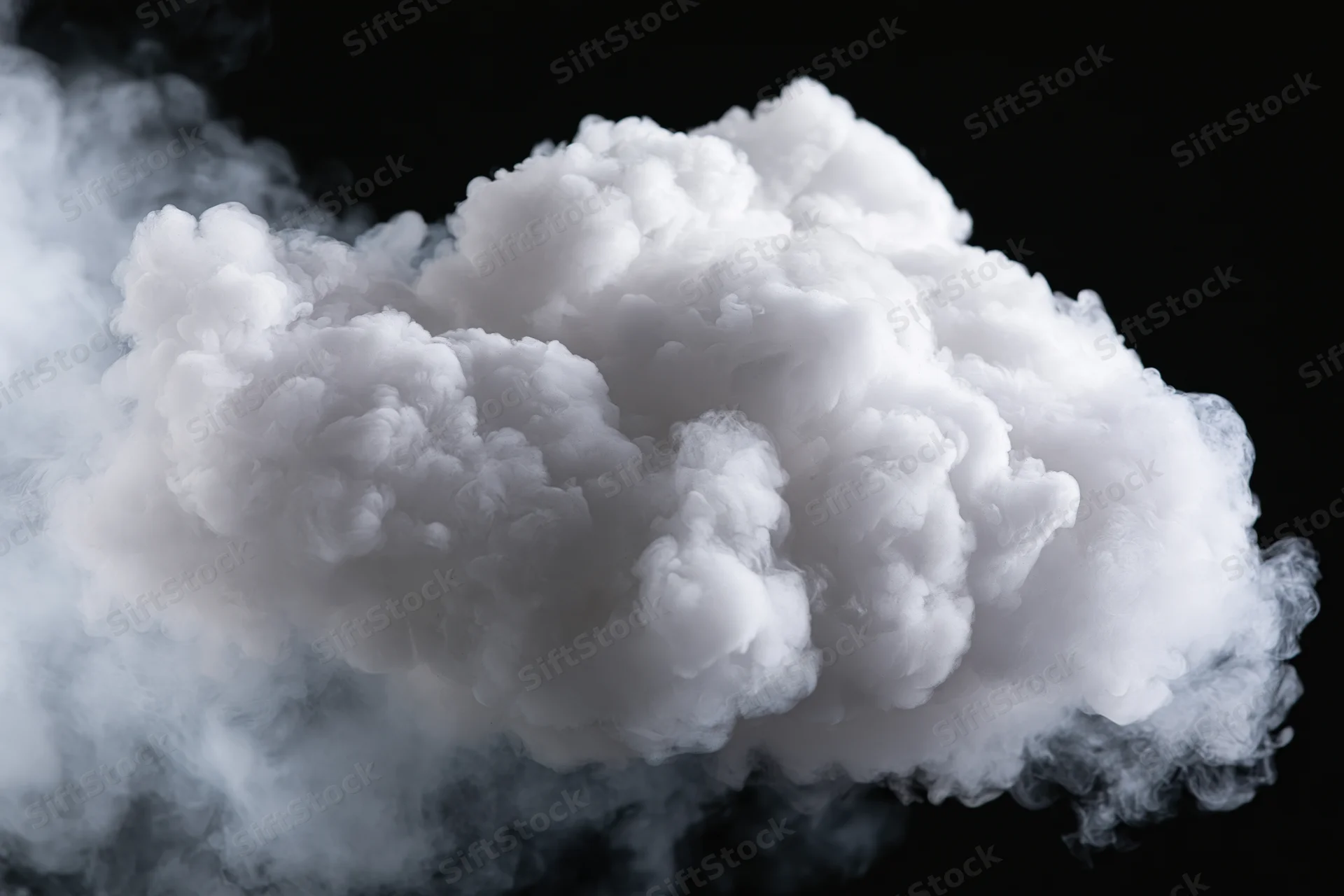 Dense white smoke billowing and expanding midair against black background