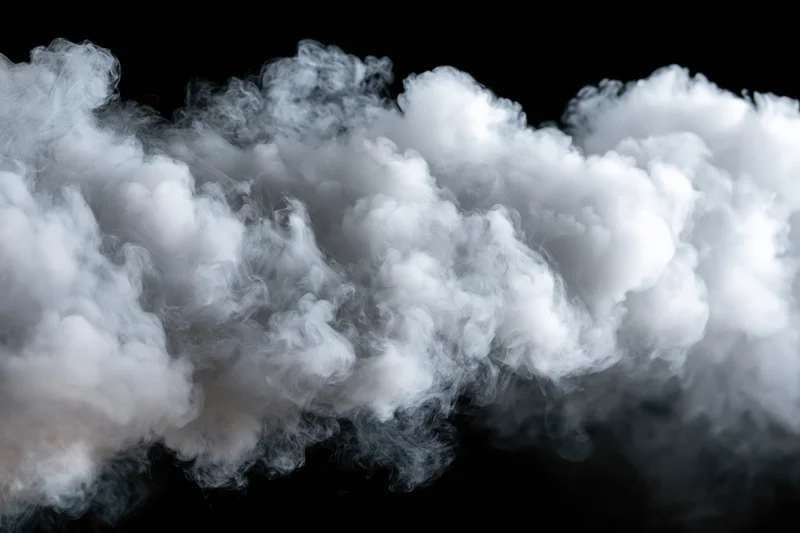 Dense white smoke billowing horizontally across black background
