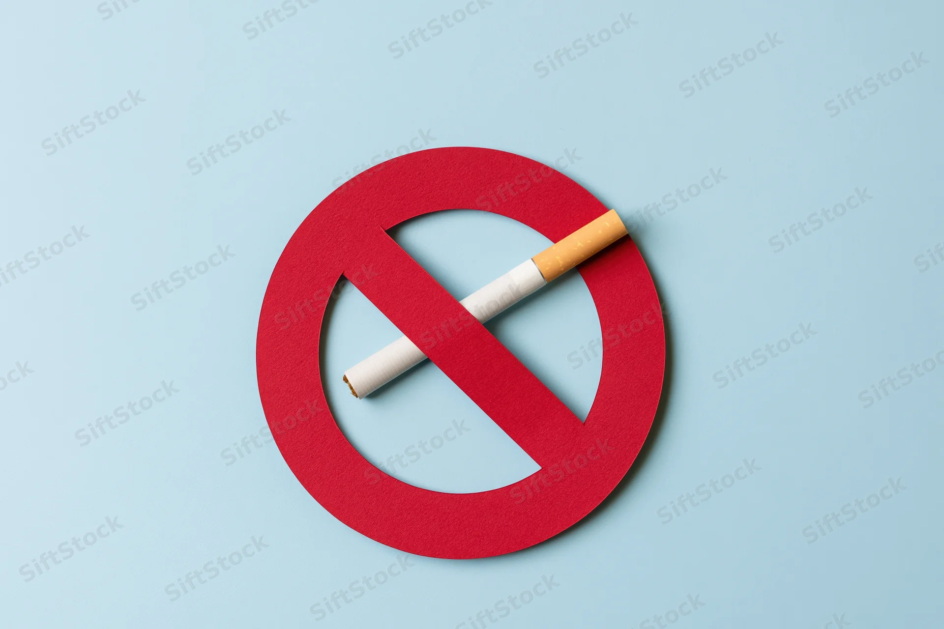 Red no-smoking symbol with cigarette on blue background