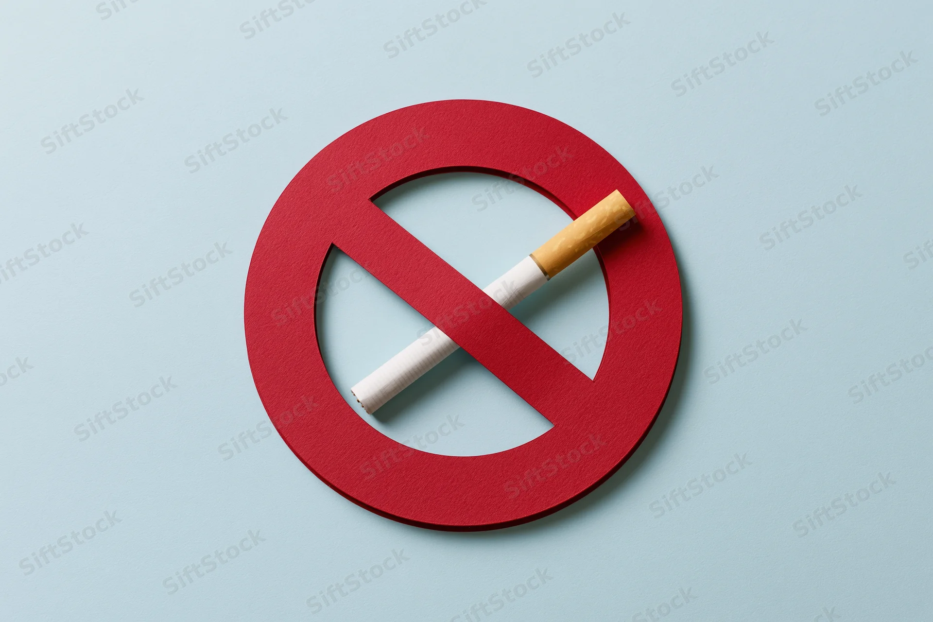 Red no-smoking symbol with cigarette inside on light blue background