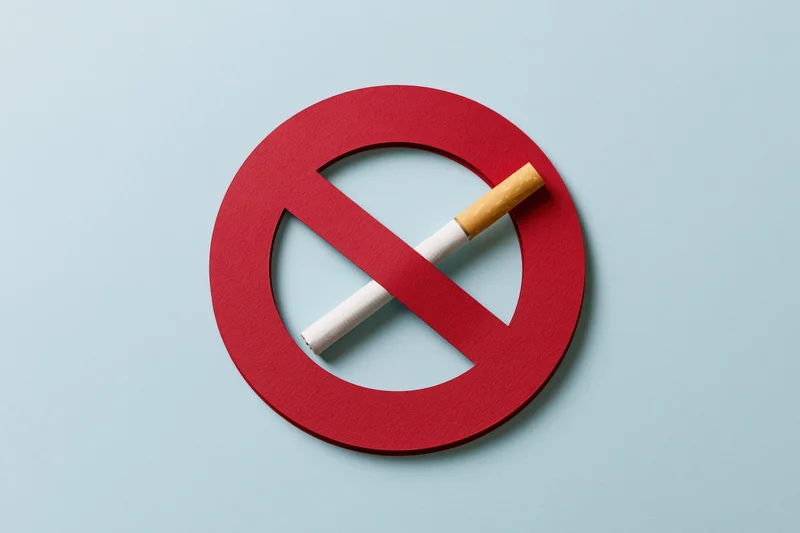 Red no-smoking symbol with cigarette inside on light blue background