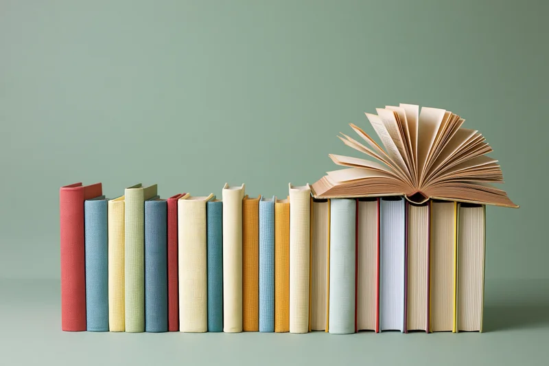 Row of hardcover books standing upright with one open at the end on a mint green background