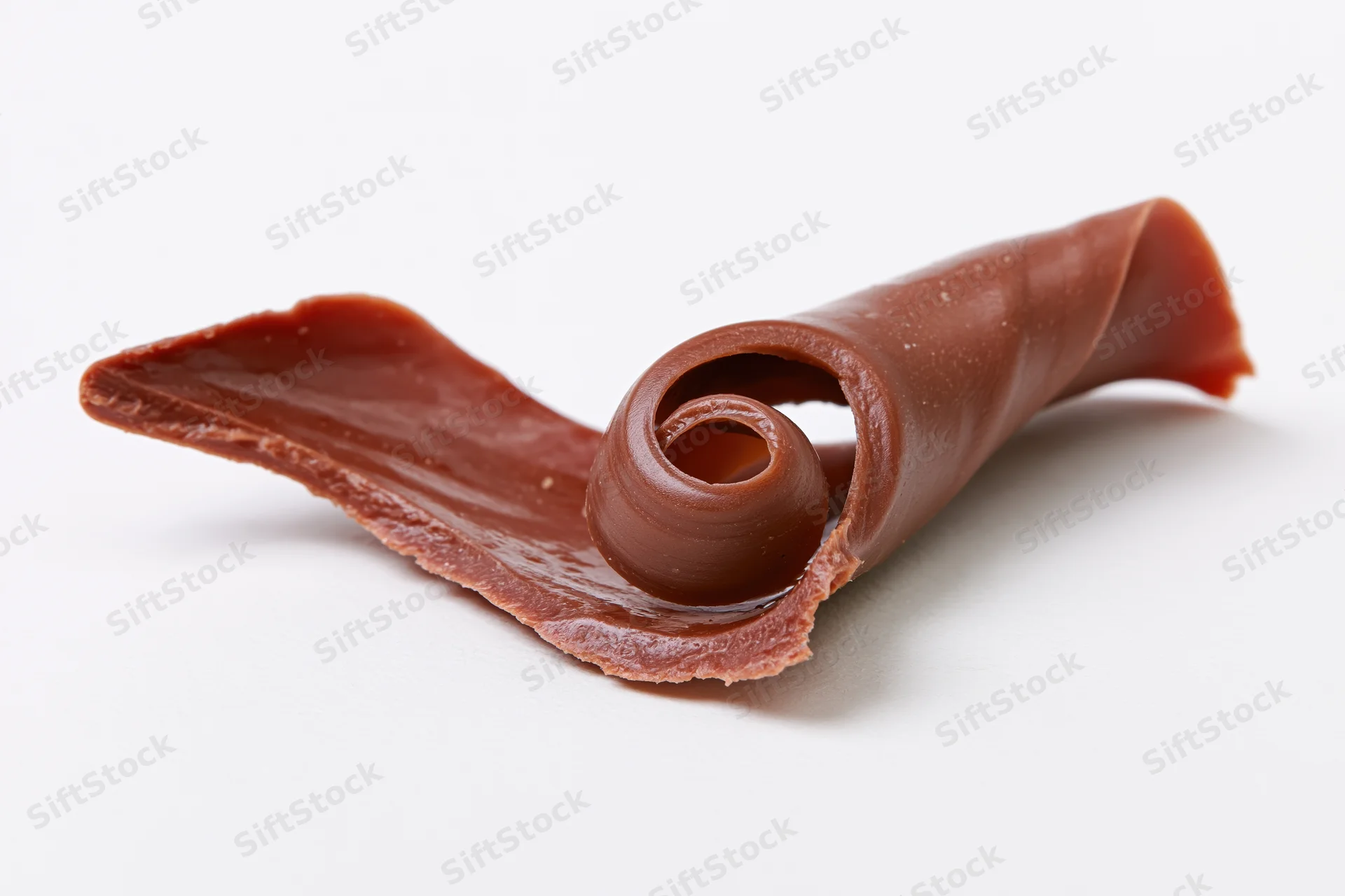 Milk chocolate curl shaving on white background