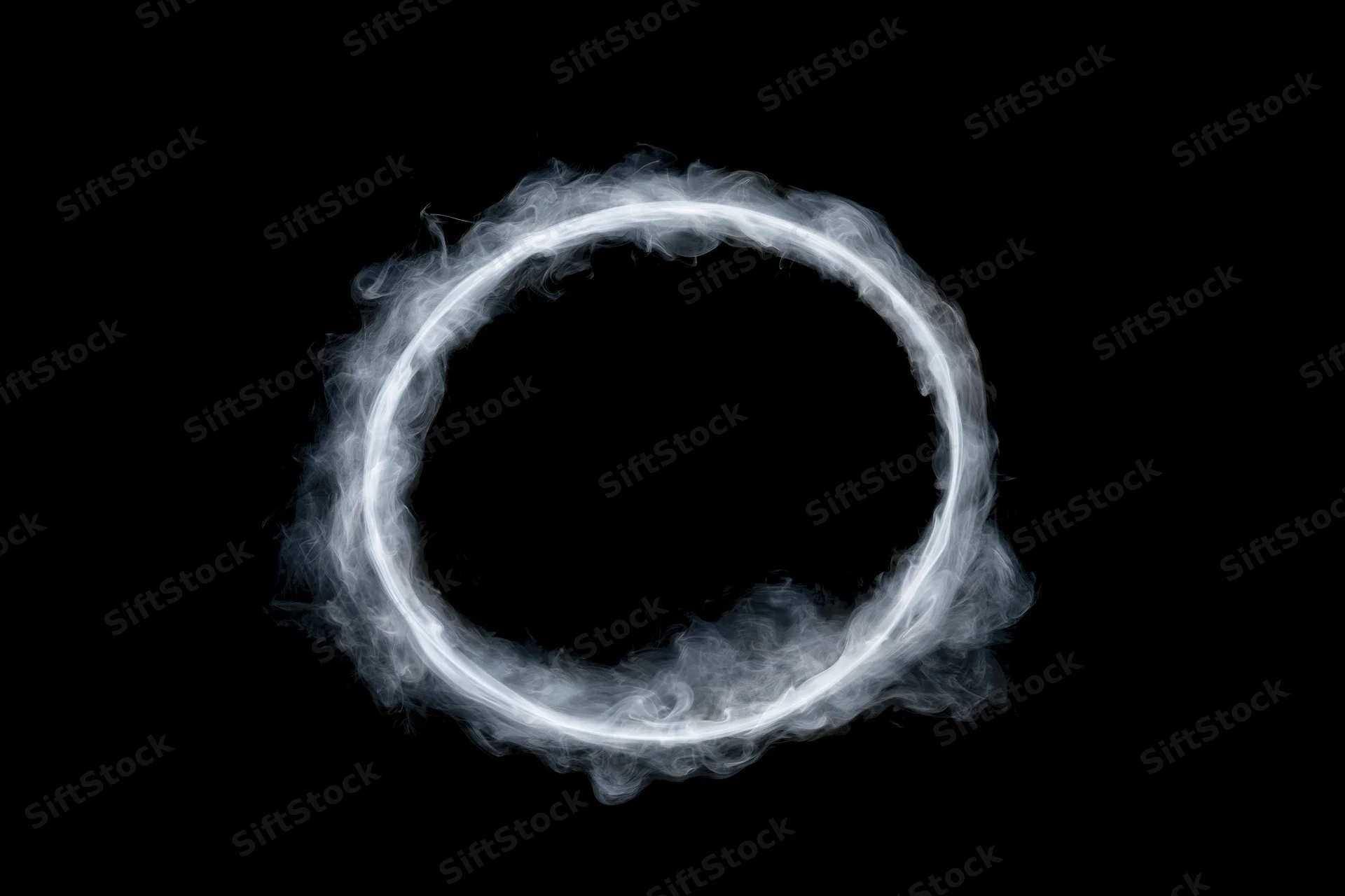 White smoke ring floating in midair against black background