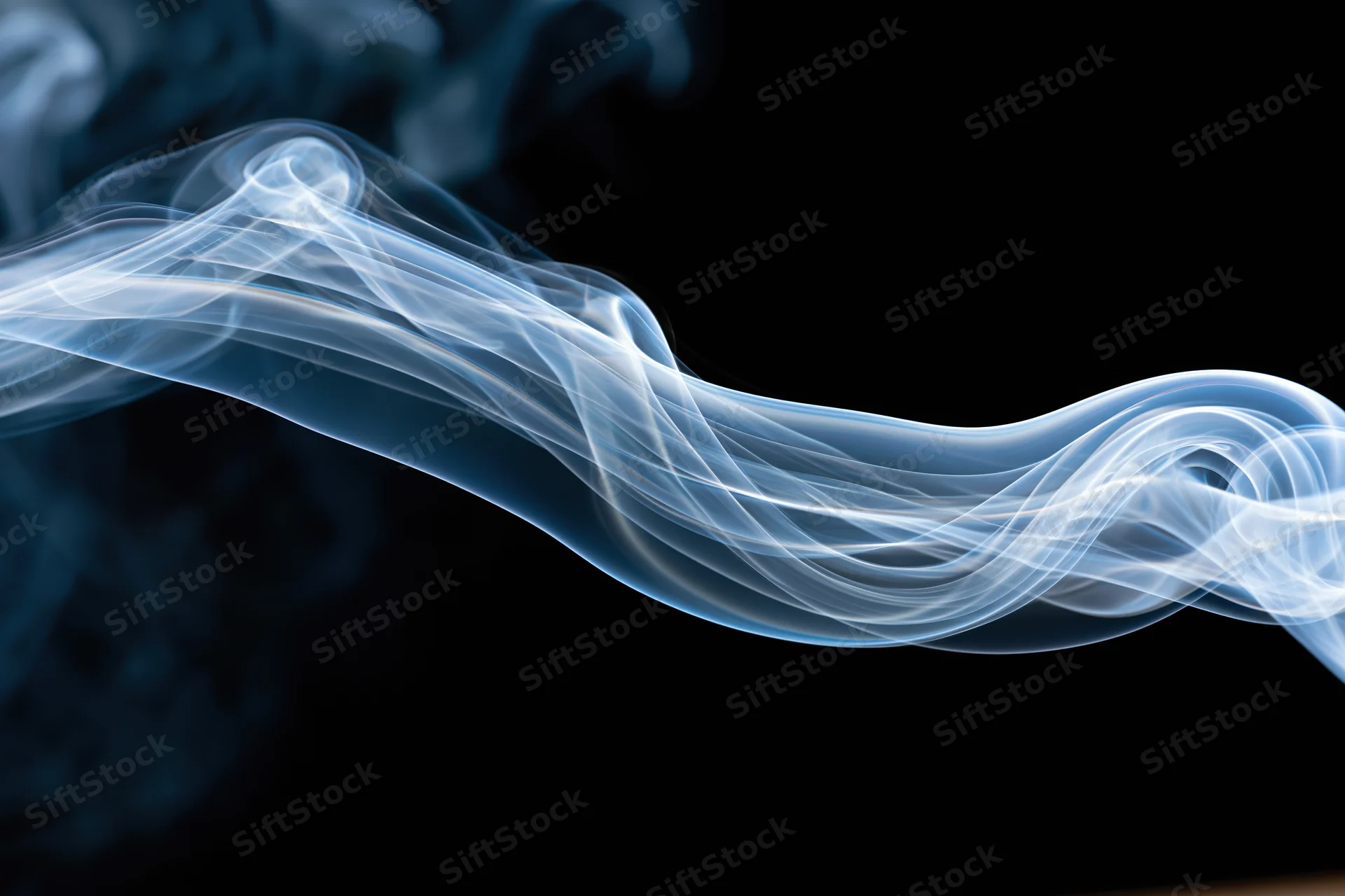 A single wisp of smoke curling and twisting horizontally across a black background