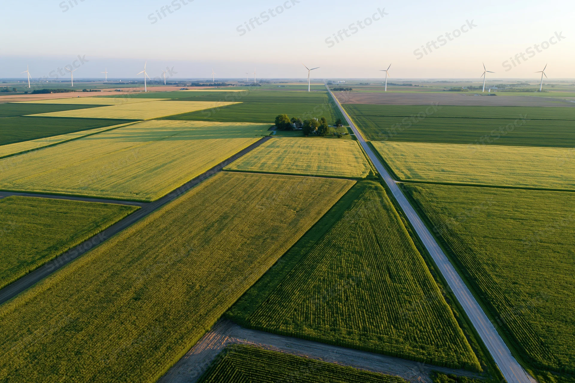 Aerial view of cultivated fields and wind turbines in midwestern farmland