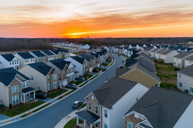 Aerial view of a new suburban residential development at sunset