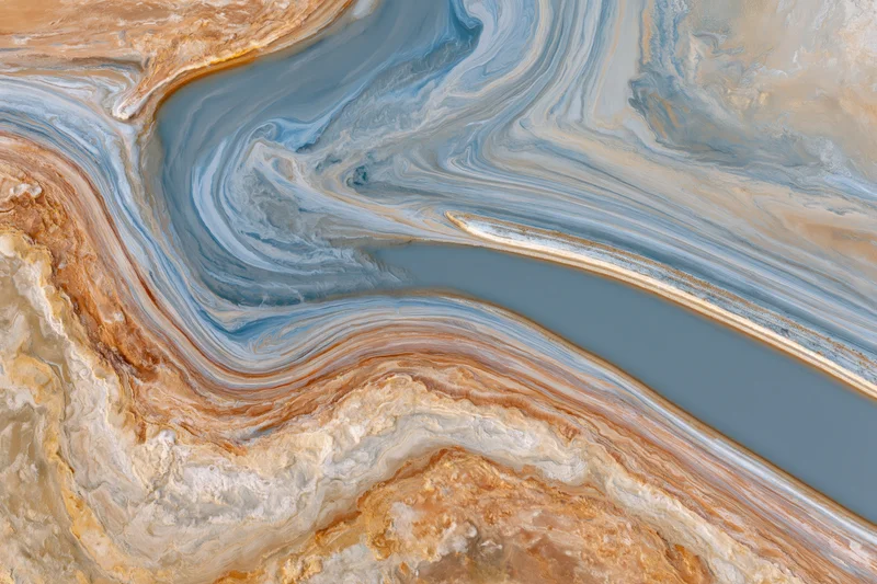 Aerial top-down view of a salt lake landscape with swirling mineral patterns and sediment layers