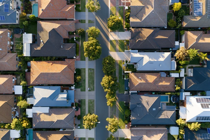 Aerial top-down view of suburban residential neighborhood with houses and streets in australia