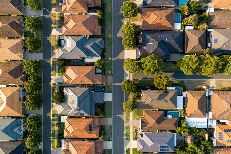 Aerial top-down view of suburban residential neighborhood with houses and streets in australia