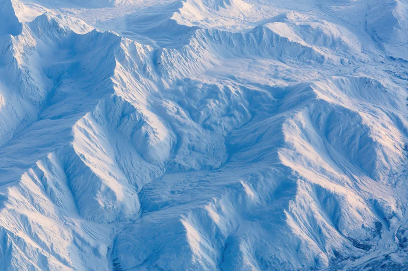 Aerial view of snow-covered mountain range from directly above