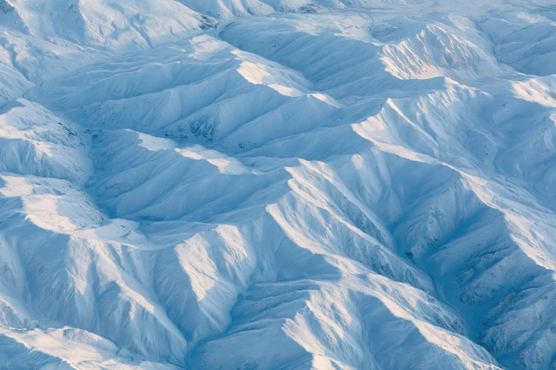 Aerial view of snow-covered mountain range from directly above