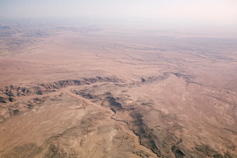 Aerial view of vast arid desert landscape from high altitude
