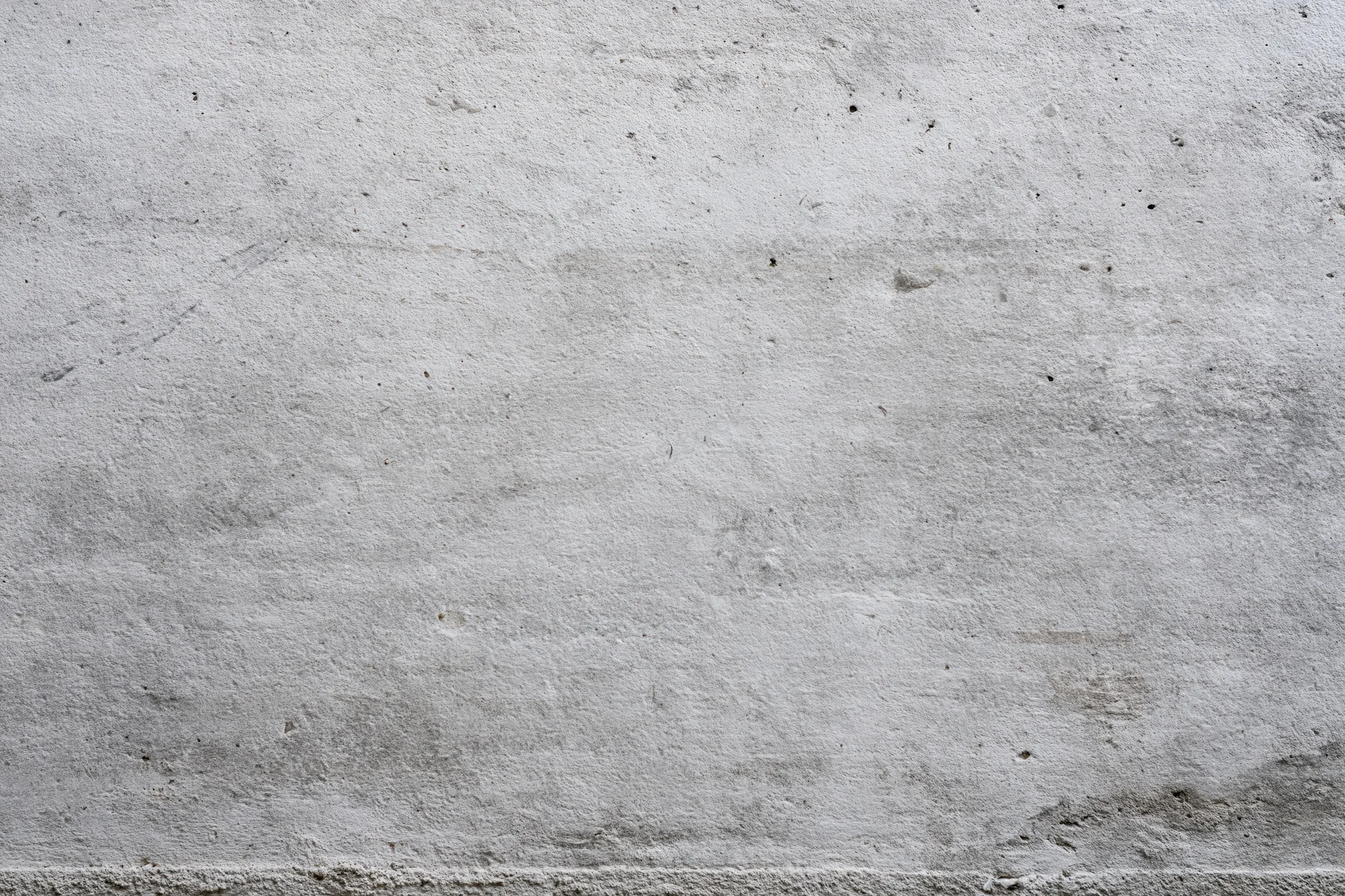 Close-up of a weathered concrete wall surface showing texture and imperfections